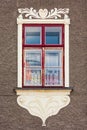 Window on a historic building decorated with sgraffito. Royalty Free Stock Photo