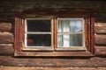 Window in the hut.  Old wooden window in a log house.  Peasant house in the village. Royalty Free Stock Photo