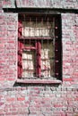 The window with iron grate of old red brick building Royalty Free Stock Photo