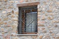 Window with iron grating on old stone wall Royalty Free Stock Photo