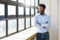 Window, lens flare and a business man arms crossed in the office with a smile or mindset of future success. Happy Royalty Free Stock Photo