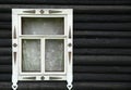 The window of a log country house is decorated with a simple pattern Royalty Free Stock Photo