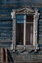 Window with lugged architrave as part of old blue wooden house