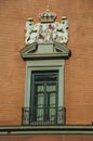 Window with luxurious decoration on bricks facade in Madrid