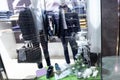 the window of a men\'s clothing and shoe store is decorated with mannequin