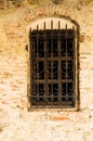 Window with metal grate on a brick wall Royalty Free Stock Photo
