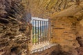 Window with metal grill between old thick stone walls of the ruined castle of Esch-sur-Sure Royalty Free Stock Photo