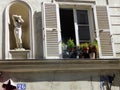 Statue near a window in a building of Montmartre in Paris in France.