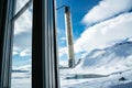 Window mounted thermometer in the arctic highland with snow capped mountains