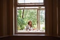 Window, nature and woman person journaling in home, porch or sun room for relax. Spring, writing and reading with coffee Royalty Free Stock Photo