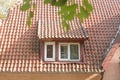 Window in old attic with tiled roof. Part of facade building from last century. Selective focus Royalty Free Stock Photo