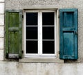Window with old blue and green shutters Royalty Free Stock Photo