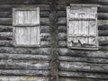 The window of the old boarded wooden log house on the background of wooden walls Royalty Free Stock Photo