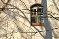 Window of an old chapel with shadows of tree branches