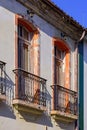 Window of old colonial style house with balcony and colorful frame Royalty Free Stock Photo