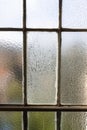 Window in old constructivist house with frost on the glass