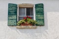 Window in an old house decorated with flower pots Royalty Free Stock Photo