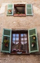 Window in an old house decorated with flower pots Royalty Free Stock Photo