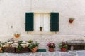 Window in an old house decorated with flower pots Royalty Free Stock Photo