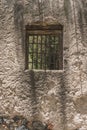 Window of an old house in a wall of adobes and quarry Royalty Free Stock Photo