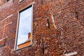 Window on the old red brick building. Old retro house made of the red bricks. Royalty Free Stock Photo