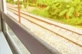 Window old of train run travel in countryside with sun light. select focus with shallow depth of field and blurred background Royalty Free Stock Photo