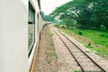 Window old of train run travel in countryside with sun light. select focus with shallow depth of field and blurred background Royalty Free Stock Photo