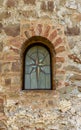 Window in the old wall of church 