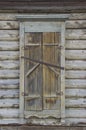 The window of an old wooden house, closed with shutters Royalty Free Stock Photo