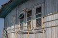 The window of the old wooden log house on the background of wooden walls Royalty Free Stock Photo