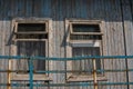 The window of the old wooden log house on the background of wooden walls Royalty Free Stock Photo