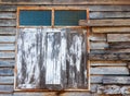 window of the old wooden log house on the background of wooden walls Royalty Free Stock Photo