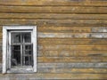 The window of the old wooden log house on the background of wooden walls Royalty Free Stock Photo