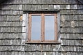 Window on old wooden village house wall Royalty Free Stock Photo