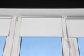 Window with open white roller blinds indoors, low angle view Royalty Free Stock Photo