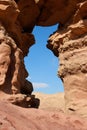 Window in the orange sandstone rock in the desert Royalty Free Stock Photo