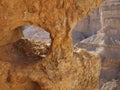 Window in the orange sandstone rock in stone deser