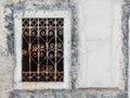 Window with ornated iron bars in a white building in Croatia