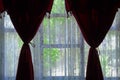 Window overlooking the garden, red curtains