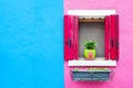 Window with pink shutters on the blue-pink wall Royalty Free Stock Photo