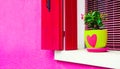 Window with pink shutters on the pink facade of the house Royalty Free Stock Photo