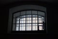 A window in a prison cell, covered with bars. Royalty Free Stock Photo