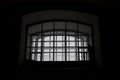 A window in a prison cell, covered with bars. Royalty Free Stock Photo