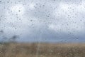 Window with rain drops on the glass outside natural landscape. Royalty Free Stock Photo