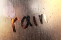 Window with raindrops. Stock photo inscription on wet glass