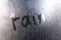 Window with raindrops. Stock photo inscription on wet glass