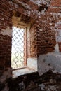 Window in a red brick wall. Ruined wall of an antique Russian church Royalty Free Stock Photo