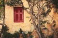 Window with red shutter of Anafiotika in town of Athens,Greece.