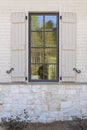 Window reflection with shutters Royalty Free Stock Photo