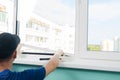 A window repairman fixes the glass to the frame with a glazing bead and a hammer Royalty Free Stock Photo